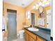 Cozy bathroom featuring a shower, vanity with storage, and bright natural light at 63 Walnut Crse, Ocala, FL 34480
