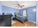 Comfortable bedroom with wood floors, a ceiling fan, and a window at 63 Walnut Crse, Ocala, FL 34480