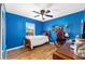 Bright bedroom with wood floors, a ceiling fan, and a window at 63 Walnut Crse, Ocala, FL 34480
