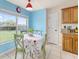 Bright dining area features a table with chairs, a window, and access to the kitchen at 63 Walnut Crse, Ocala, FL 34480