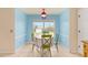 Charming dining area featuring a table with seating, a window view, and tile flooring at 63 Walnut Crse, Ocala, FL 34480