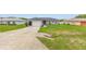 Inviting single-story home featuring a spacious driveway, lush lawn and an attached two-car garage for easy access at 63 Walnut Crse, Ocala, FL 34480