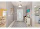 Inviting foyer with neutral walls, an accent table and an elegant front door with easy access to the laundry room at 63 Walnut Crse, Ocala, FL 34480