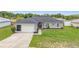 Charming single-story home with an attached garage, landscaped front yard, and welcoming entrance at 63 Walnut Crse, Ocala, FL 34480