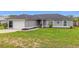 Charming single-story home featuring an attached garage, well-manicured lawn, and an inviting front entrance at 63 Walnut Crse, Ocala, FL 34480