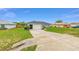 Charming single-story home with a well-maintained front yard and a long driveway at 63 Walnut Crse, Ocala, FL 34480