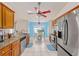 Bright kitchen with stainless steel appliances, granite countertops, and a breakfast table in front of a large window at 63 Walnut Crse, Ocala, FL 34480
