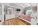 Spacious main bedroom featuring a tray ceiling, wood floors, and a large window at 63 Walnut Crse, Ocala, FL 34480