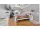 Inviting main bedroom featuring hardwood floors, a tray ceiling, and large window at 63 Walnut Crse, Ocala, FL 34480