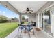 Cozy covered patio features outdoor seating and direct access to the home's interior at 63 Walnut Crse, Ocala, FL 34480