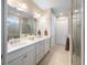 Bathroom featuring double vanity sinks, white cabinets, and a walk-in shower at 6776 Sw 95Th Cir, Ocala, FL 34481