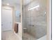 Modern bathroom featuring a glass-enclosed shower with a built-in seat and neutral tile at 6776 Sw 95Th Cir, Ocala, FL 34481