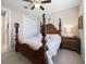 Cozy bedroom with detailed four-poster bed, ceiling fan and soft neutral color palette at 6776 Sw 95Th Cir, Ocala, FL 34481