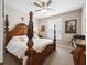 A bedroom featuring a detailed four-poster bed, ceiling fan, and lots of natural light at 6776 Sw 95Th Cir, Ocala, FL 34481