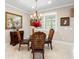Bright dining area with elegant chandelier, decorative chairs, and bright natural light at 6776 Sw 95Th Cir, Ocala, FL 34481