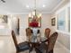Bright dining area with elegant chandelier, decorative chairs, and bright natural light at 6776 Sw 95Th Cir, Ocala, FL 34481