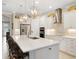 Spacious kitchen boasts stainless appliances, white cabinetry, and a center island with seating at 6776 Sw 95Th Cir, Ocala, FL 34481