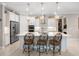 Bright kitchen features white cabinets, stainless steel appliances, and a large island with pendant lighting at 6776 Sw 95Th Cir, Ocala, FL 34481