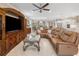 Living room featuring a large sectional sofa, entertainment center, and tiled floors at 6776 Sw 95Th Cir, Ocala, FL 34481