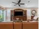 Living room with entertainment center, plantation shutters, and access to the patio at 6776 Sw 95Th Cir, Ocala, FL 34481