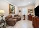 Cozy living room with leather recliners, decorative paintings, and a dark wood cabinet at 6776 Sw 95Th Cir, Ocala, FL 34481