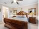 Comfortable main bedroom with a large bed, side tables, and ensuite bathroom at 6776 Sw 95Th Cir, Ocala, FL 34481