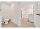 Bright bathroom featuring tile floors, a shower, vanity, and toilet at 7133 Sw 135Th Pl, Ocala, FL 34473