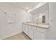 Bathroom features tile floors, a large mirror, double sinks, and granite countertops at 7133 Sw 135Th Pl, Ocala, FL 34473
