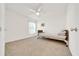 Cozy carpeted bedroom features a twin bed and a ceiling fan at 7133 Sw 135Th Pl, Ocala, FL 34473