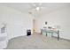Spacious carpeted bedroom with ceiling fan, closet, and access to an ensuite bathroom at 7133 Sw 135Th Pl, Ocala, FL 34473