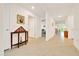 Bright hallway featuring neutral tile flooring and white walls leading to various rooms in the home at 7133 Sw 135Th Pl, Ocala, FL 34473