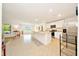 Bright, open kitchen with white cabinetry, stainless steel appliances, and a large center island perfect for gatherings at 7133 Sw 135Th Pl, Ocala, FL 34473