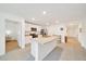 Well-lit kitchen features stainless steel appliances, center island with sink, and seamless flow to the entrance at 7133 Sw 135Th Pl, Ocala, FL 34473