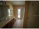 Bathroom with vanity and tile flooring, shower-tub combo, and direct access to the backyard at 8100 Sw 56Th Ter, Ocala, FL 34476