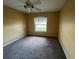 Bedroom with a window, carpet, and ceiling fan at 8100 Sw 56Th Ter, Ocala, FL 34476