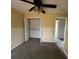 Bedroom with a ceiling fan and closet with shelves at 8100 Sw 56Th Ter, Ocala, FL 34476