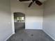 Bedroom featuring plush carpeting, neutral walls, and an arched doorway leading to the living room at 8100 Sw 56Th Ter, Ocala, FL 34476