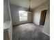 Carpeted dining room with a window and chandelier at 8100 Sw 56Th Ter, Ocala, FL 34476