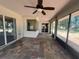 Bright screened-in lanai with tile flooring, ceiling fan and sliding glass doors, inviting you to enjoy the outdoors at 8100 Sw 56Th Ter, Ocala, FL 34476