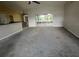 Open-concept living room with neutral walls, carpeting, connecting to the kitchen and lanai at 8100 Sw 56Th Ter, Ocala, FL 34476