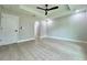 Bright bedroom featuring tray ceilings, ceiling fan, and light gray flooring at 8289 Se 159Th Ln, Summerfield, FL 34491