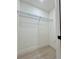 Walk-in closet with metal shelves and light gray flooring at 8289 Se 159Th Ln, Summerfield, FL 34491