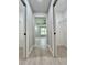 Hallway with two closet doors on each side leading to a bedroom with a tray ceiling at 8289 Se 159Th Ln, Summerfield, FL 34491