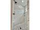 Modern shower design featuring marble tile, pebble stone floor, and rainfall shower head at 8289 Se 159Th Ln, Summerfield, FL 34491