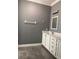 Bathroom featuring gray walls, gray tile floor, and white vanity with countertop at 8298 Sw 79Th Cir, Ocala, FL 34476