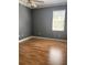 Bedroom featuring wood flooring and a large window for natural light at 8298 Sw 79Th Cir, Ocala, FL 34476