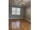 Bedroom with hardwood floors, gray walls, crown molding, and a window providing natural light at 8298 Sw 79Th Cir, Ocala, FL 34476
