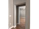 View of the bedroom through an arched opening, revealing hardwood floors and a ceiling fan at 8298 Sw 79Th Cir, Ocala, FL 34476