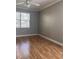 Bedroom with hardwood floors, gray walls, crown molding, and a window providing natural light at 8298 Sw 79Th Cir, Ocala, FL 34476