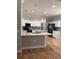 Bright, open kitchen with white cabinets, stainless steel appliances, and hardwood floors at 8298 Sw 79Th Cir, Ocala, FL 34476